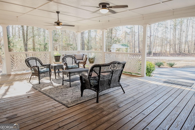 wooden terrace featuring outdoor lounge area and ceiling fan