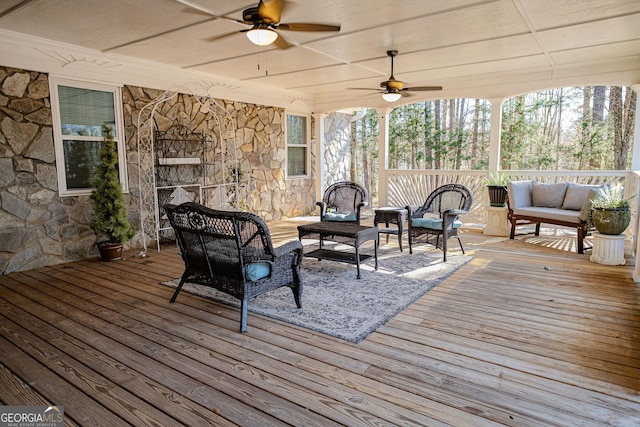 wooden terrace featuring an outdoor living space and ceiling fan