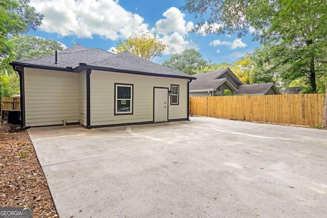 rear view of property featuring central AC unit