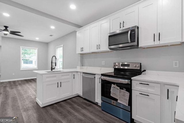 kitchen with white cabinets, appliances with stainless steel finishes, and sink