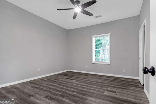 spare room with dark hardwood / wood-style floors and ceiling fan