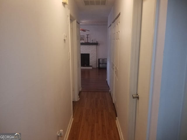 corridor with dark hardwood / wood-style floors