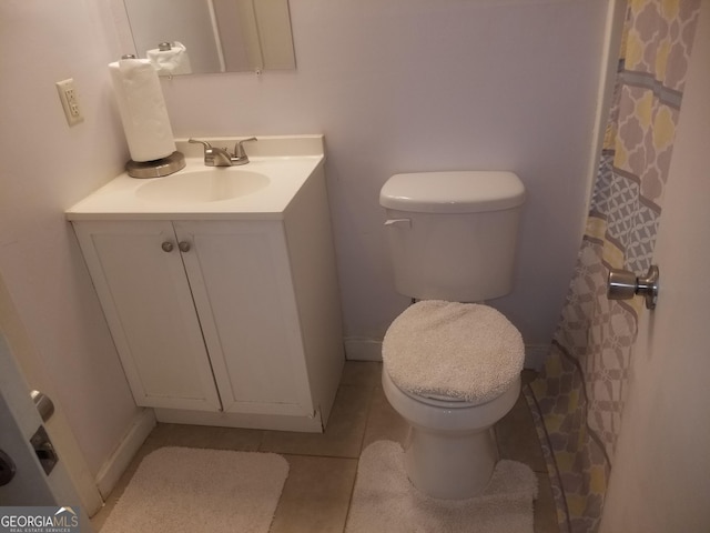 full bathroom featuring toilet, vanity, and tile patterned floors