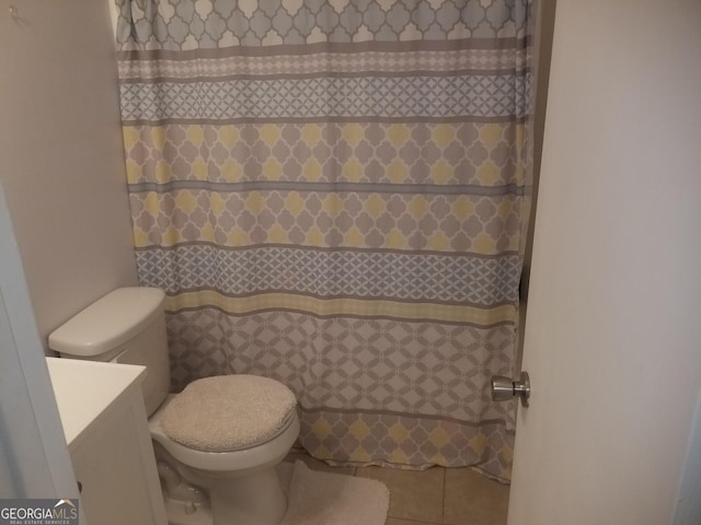 bathroom featuring tile patterned flooring, vanity, and toilet