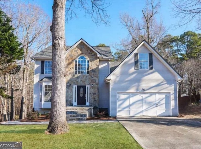 view of front facade with a garage and a front lawn