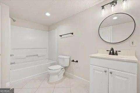 full bathroom featuring tile patterned floors, vanity, toilet, and tub / shower combination