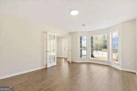 unfurnished room with dark hardwood / wood-style flooring