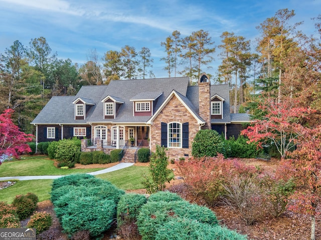 cape cod-style house featuring a front yard