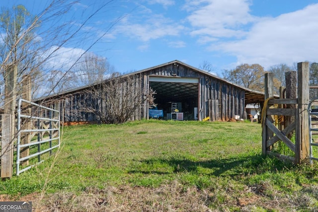 view of outbuilding featuring a lawn