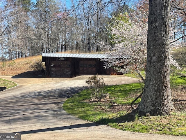 view of property exterior with an outdoor structure