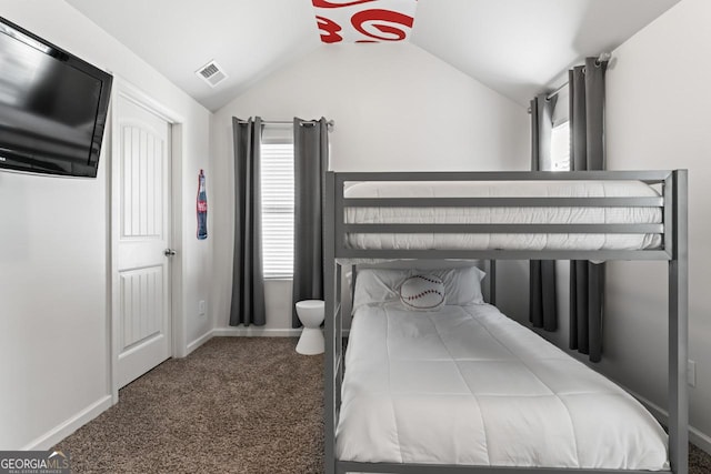 carpeted bedroom with lofted ceiling