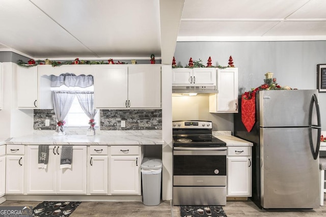 kitchen featuring decorative backsplash, light stone countertops, white cabinetry, and appliances with stainless steel finishes