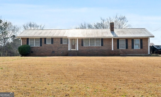 view of front of home with brick siding, a chimney, metal roof, crawl space, and a front yard