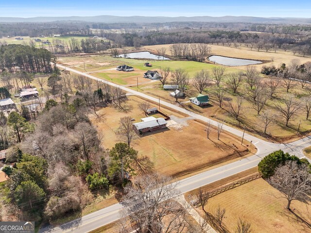 birds eye view of property with a mountain view and a rural view