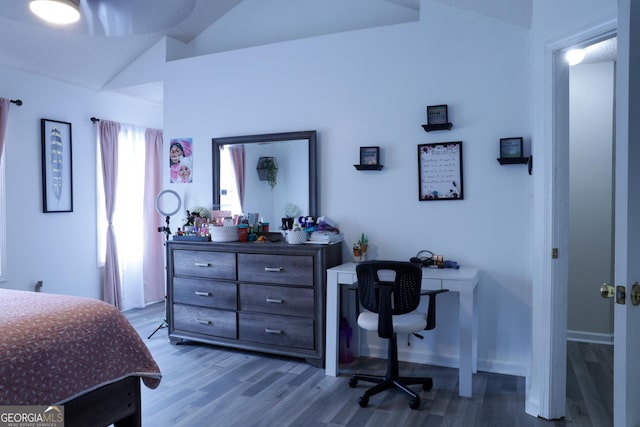 bedroom featuring light hardwood / wood-style floors and vaulted ceiling