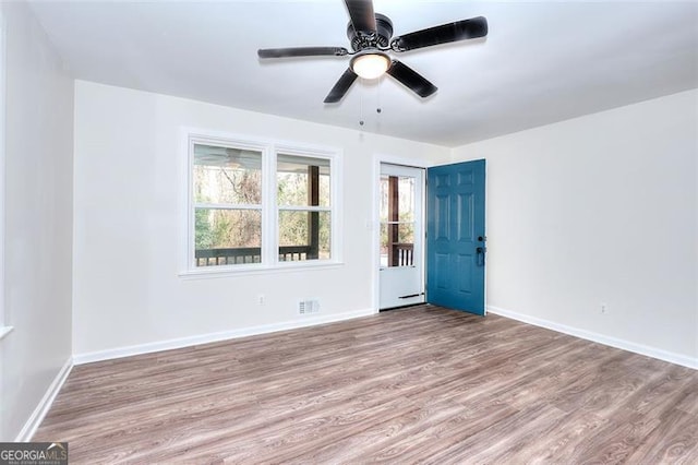 empty room featuring ceiling fan and light hardwood / wood-style flooring