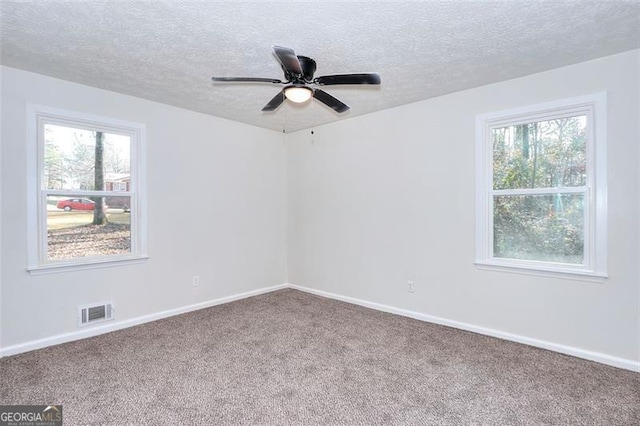 unfurnished room with carpet flooring, ceiling fan, and a healthy amount of sunlight