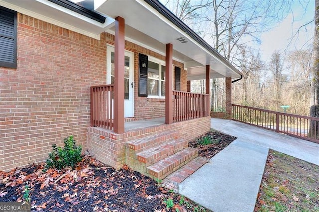 wooden terrace featuring a porch