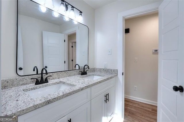 bathroom with hardwood / wood-style flooring and vanity