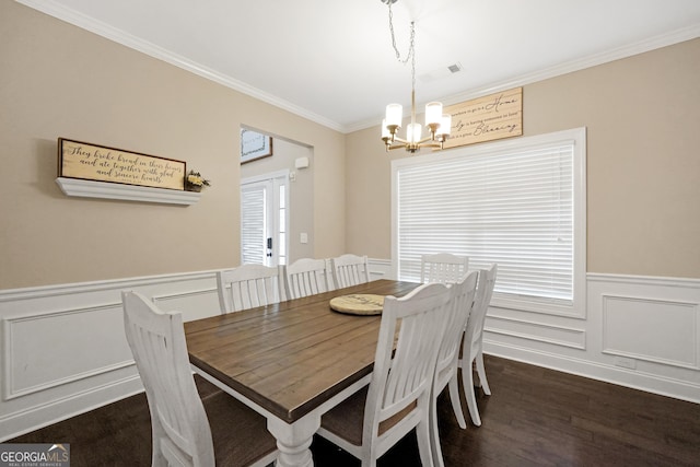 dining area featuring a chandelier, dark hardwood / wood-style flooring, and ornamental molding