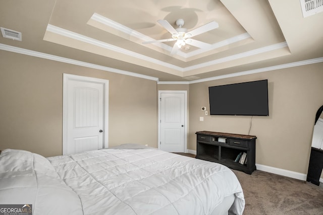 carpeted bedroom featuring a tray ceiling, ceiling fan, and ornamental molding