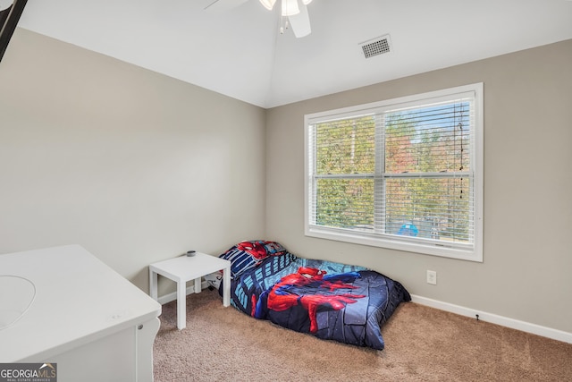 bedroom with ceiling fan, light carpet, and vaulted ceiling