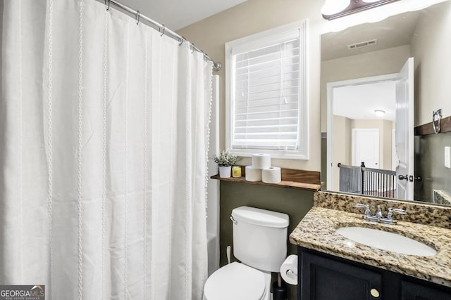 bathroom with vanity and toilet