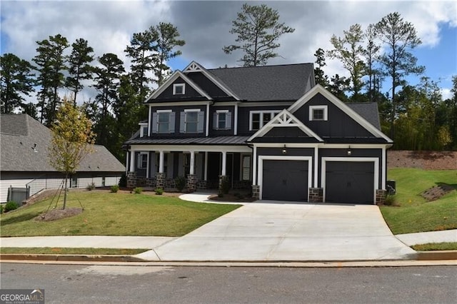 craftsman house with a porch, a garage, and a front yard