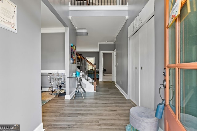 foyer entrance featuring hardwood / wood-style flooring and ornamental molding