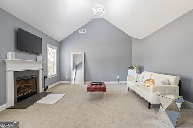 living room with light colored carpet and lofted ceiling