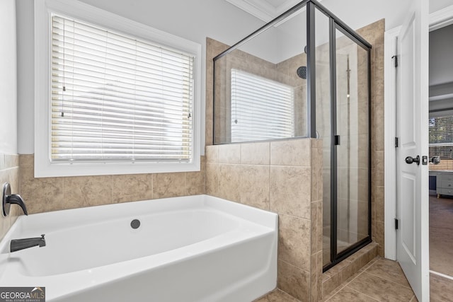 bathroom featuring separate shower and tub, tile patterned floors, and a healthy amount of sunlight