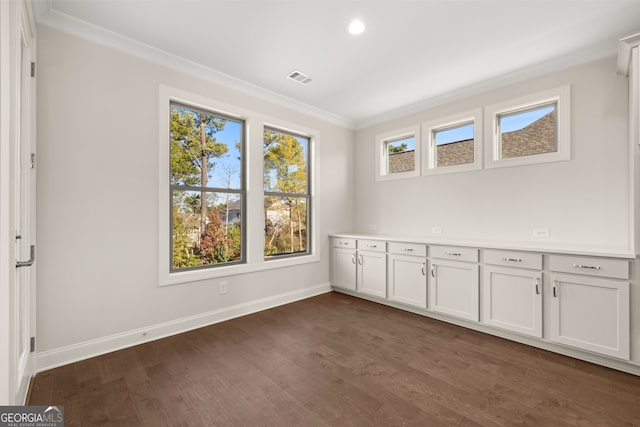 spare room with crown molding and dark hardwood / wood-style floors