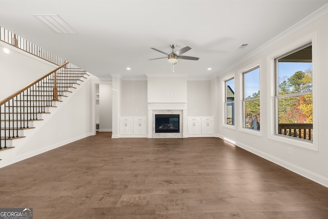 unfurnished living room featuring crown molding, ceiling fan, a fireplace, and dark hardwood / wood-style flooring