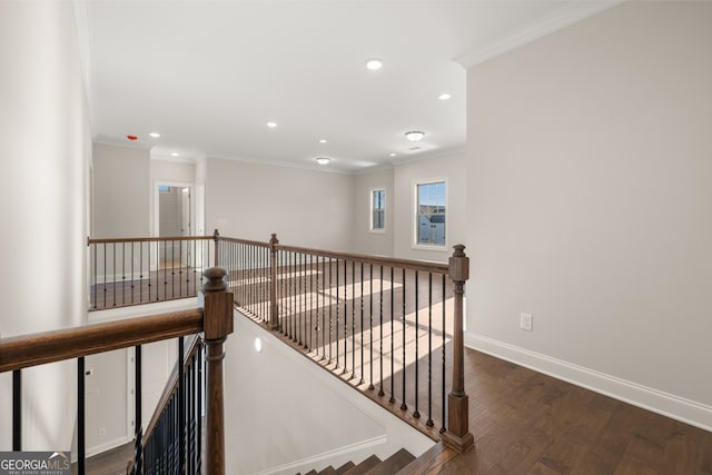 staircase featuring ornamental molding and hardwood / wood-style floors