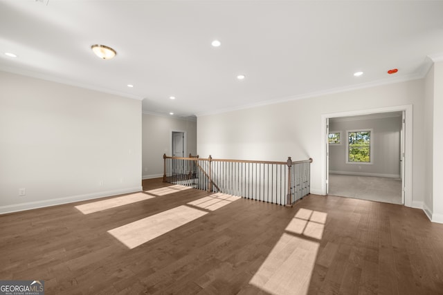 spare room with dark wood-type flooring and ornamental molding