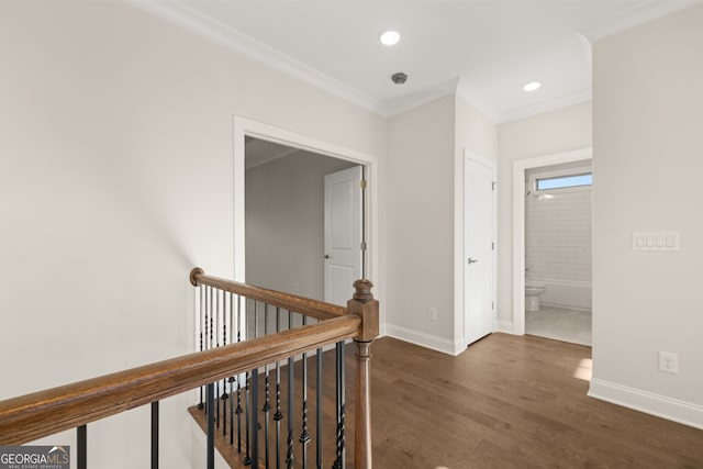 corridor with ornamental molding and dark hardwood / wood-style flooring