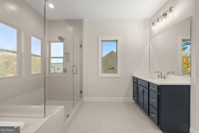 bathroom with vanity, a shower with shower door, and tile patterned floors