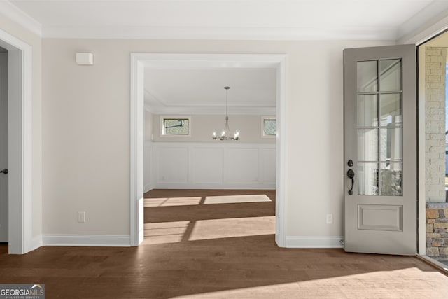 interior space featuring a notable chandelier, crown molding, and dark hardwood / wood-style floors