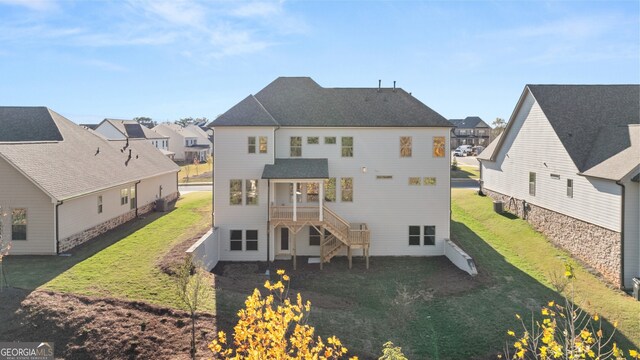 rear view of house featuring a lawn