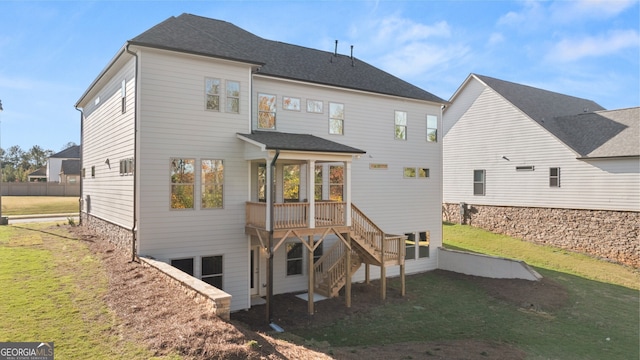 rear view of property with a yard