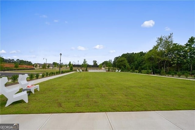 view of property's community with a lawn