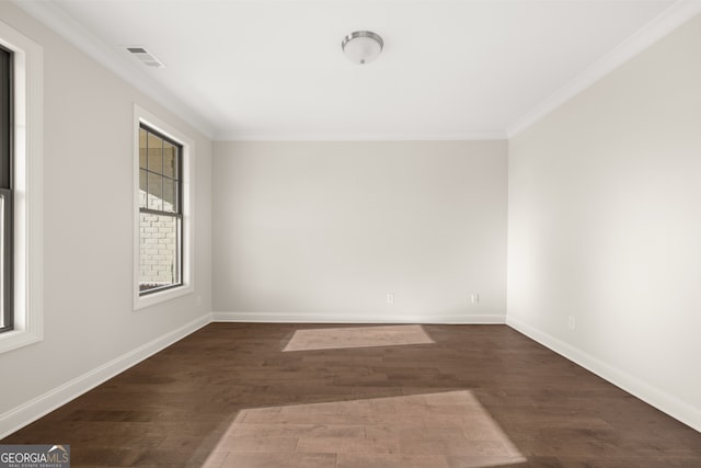 unfurnished room featuring ornamental molding and dark hardwood / wood-style flooring