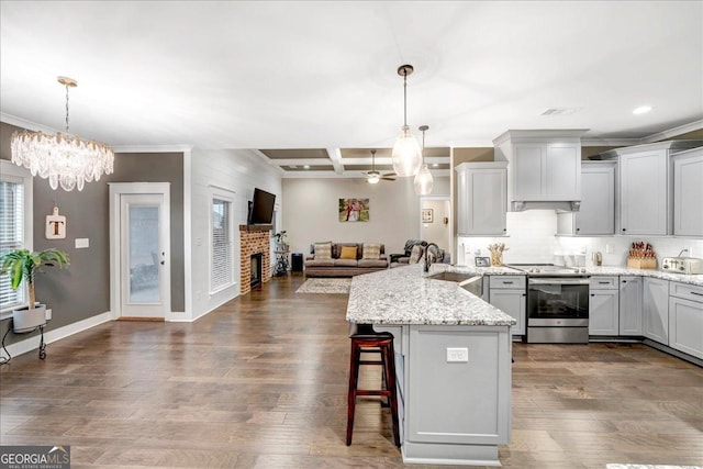 kitchen featuring beam ceiling, stainless steel electric range oven, sink, hanging light fixtures, and coffered ceiling