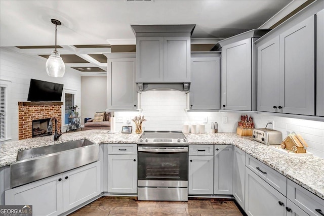 kitchen with stainless steel electric range oven, coffered ceiling, backsplash, pendant lighting, and a fireplace