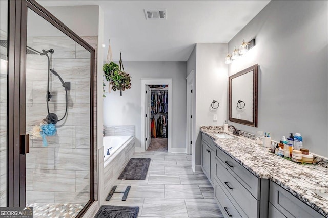 bathroom with vanity and plus walk in shower