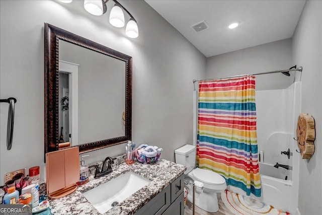 full bathroom featuring vanity, toilet, and shower / bath combo with shower curtain