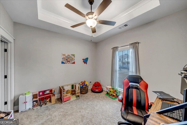 playroom with a tray ceiling, ceiling fan, and carpet floors