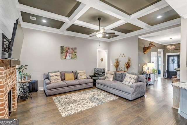 living room with beam ceiling, ceiling fan with notable chandelier, dark hardwood / wood-style floors, and coffered ceiling