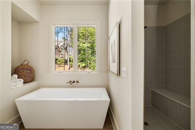 bathroom featuring separate shower and tub