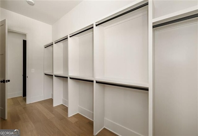 spacious closet featuring light hardwood / wood-style floors